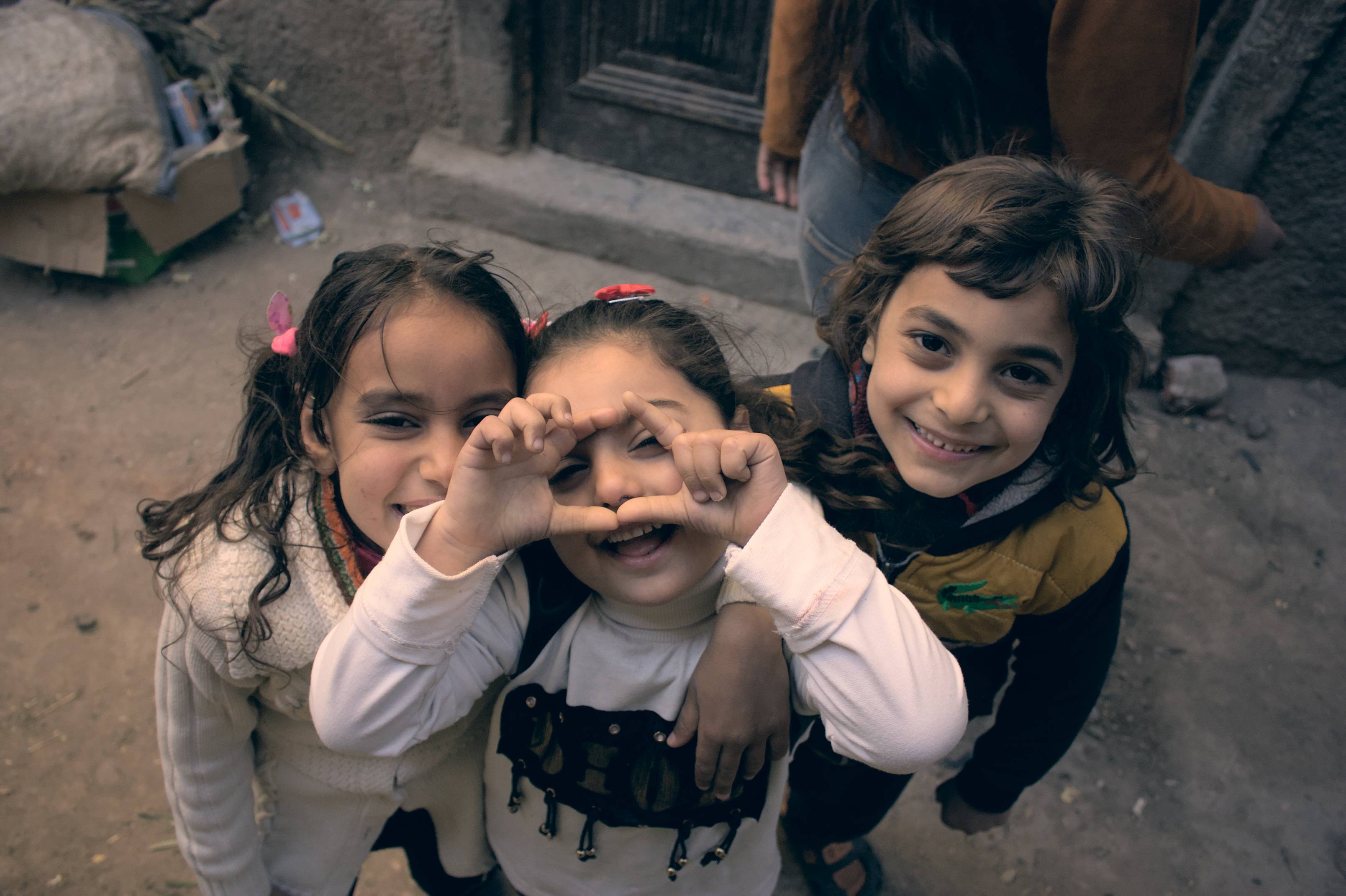 two-girls-and-a-boy-smile-at-camera.jpg